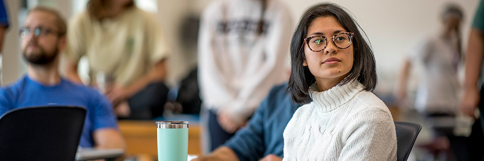 Communication Sciences and Disorders Student sits in class.