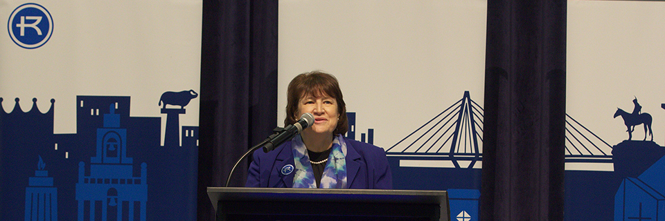 Sandra Cassady speaks behind a podium Sandra Cassady introduced as the 15th president of Rockhurst University