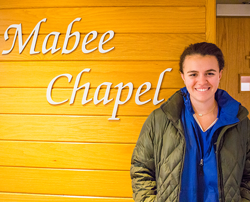 Clare Mitchell stands outside of the Mabee Chapel.