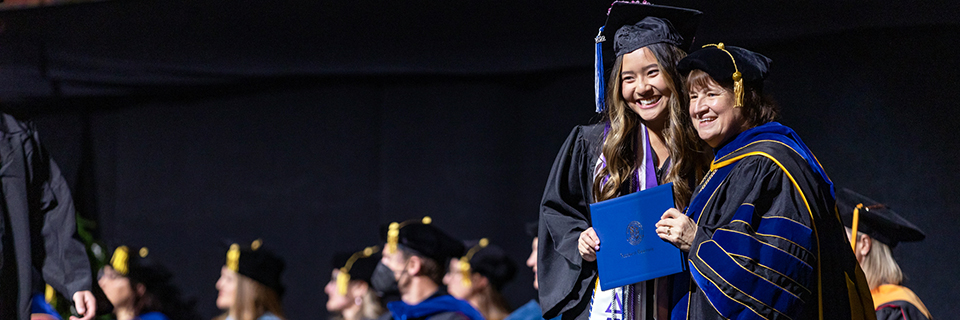 Dr. Cassady and Nhukim Nguyen holding a diploma Commencement, December 2023