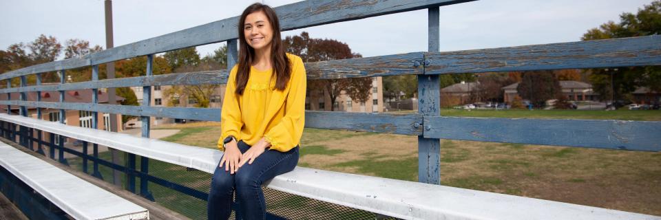 Emily Dickson sits on the bleachers on bourke field