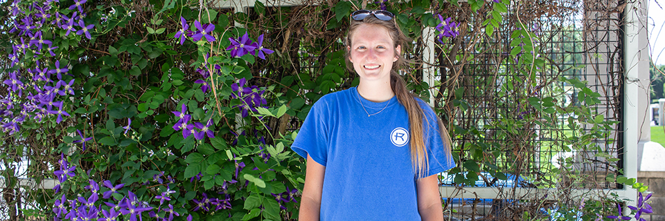 Hannah Nelligan stands in front of pergola