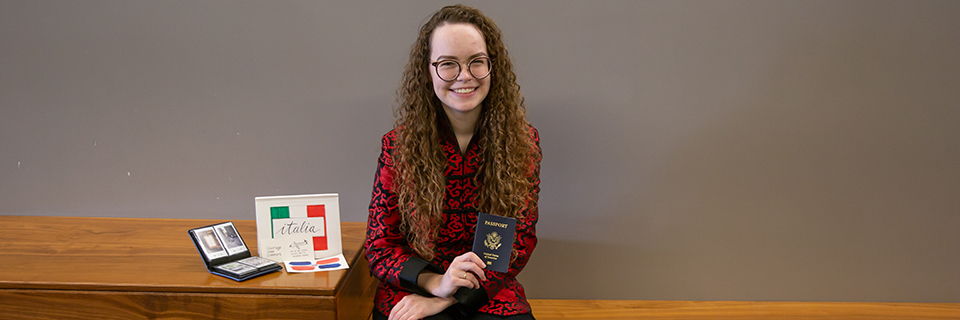 Janelle Dempsey sits on a bench in Arrupe hall. 