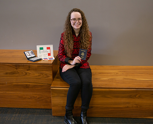 Janelle Dempsey sits on a bench in Arrupe hall.