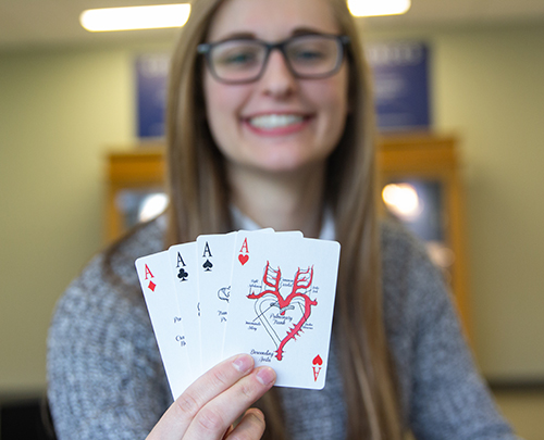 Kaley Marcinski holds up her anatomy cards for a photo. 