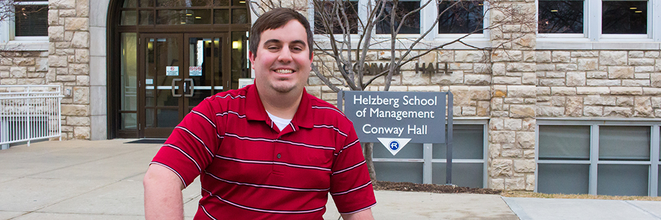 Kevin Burjarski sits on a bench outside of Conway hall