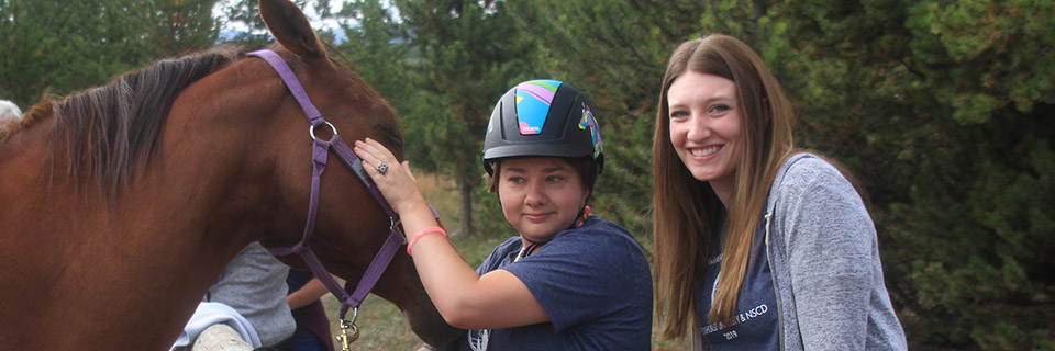 OT student working with patient and horse