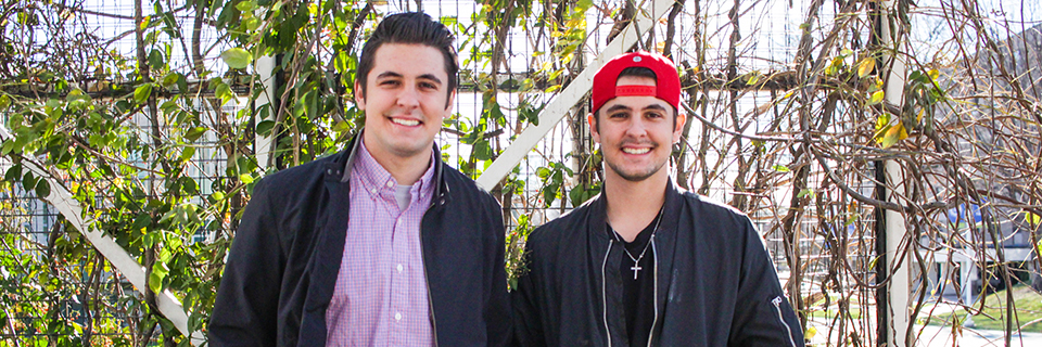 Jake and Pete Randall standing in front of pergola at Rockhurst University