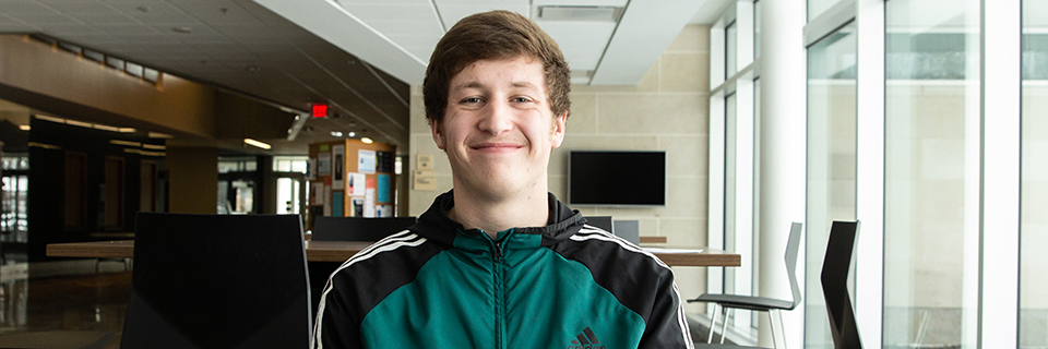 Nelson Searcy poses for a photo in Arrupe Hall. 