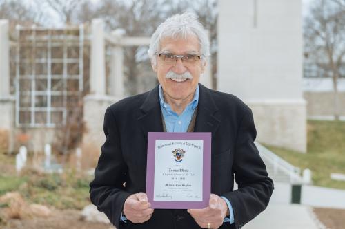 Turner White holding Delta Sigma Pi Midwestern Region Chapter Advisor of the Year award