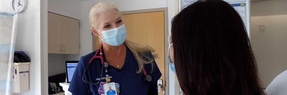 Nurse Lori Walters talks to a patient