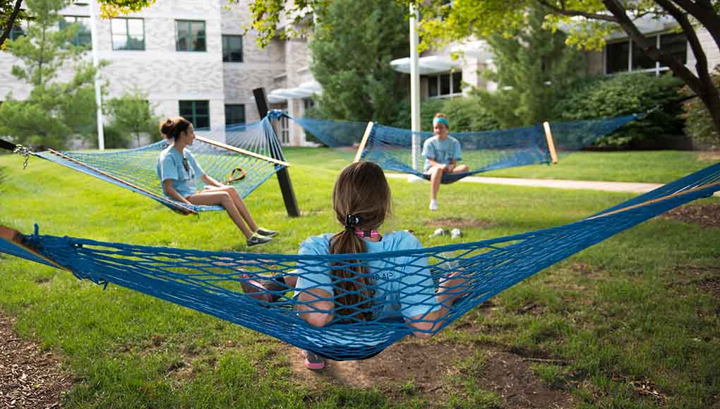 Students utilizing their free time students in hammocks
