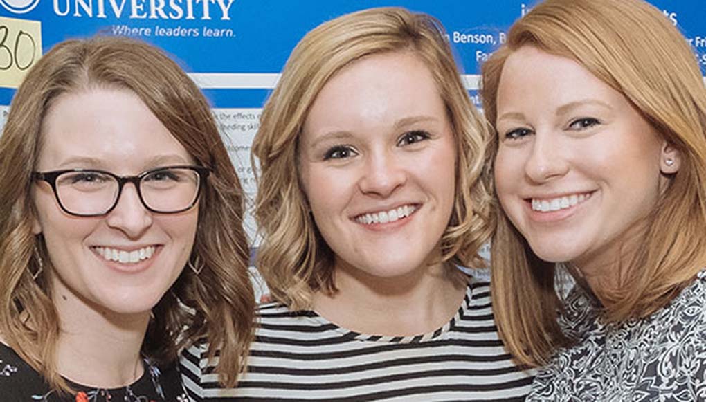 students smiling at event