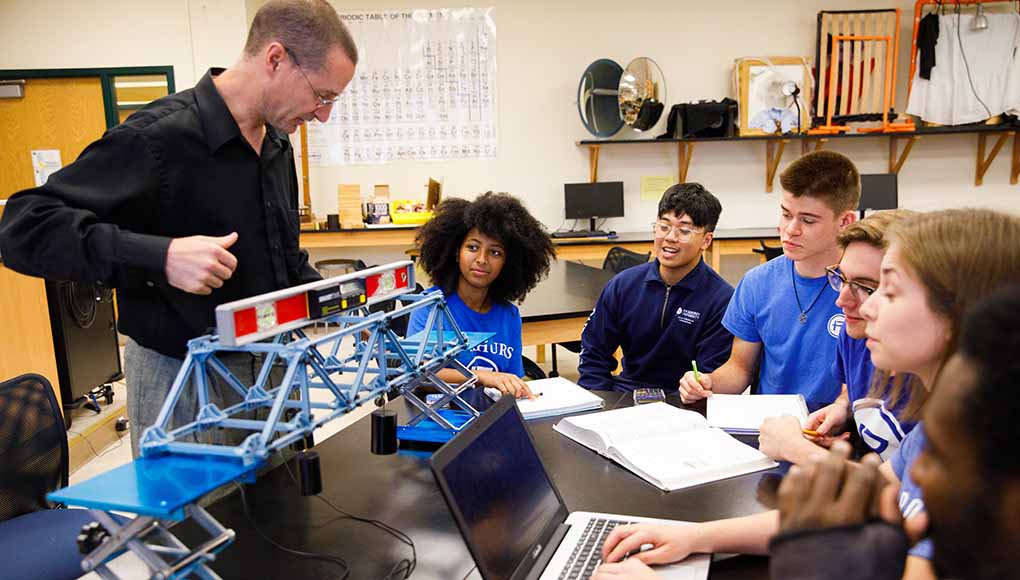 Succeeding Students in class with teacher
