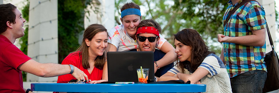 Apply to Rockhurst students looking at laptop