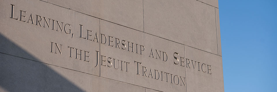 Bell tower inscription. Learning, leadership, and service in the Jesuit tradition