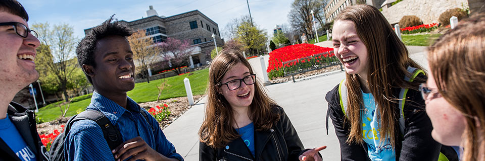 Business Communication students talking to each other on campus