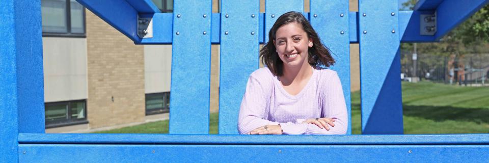 Caroline Adams, '20 Caroline Adams sits in the big blue Adirondack chair on campus.