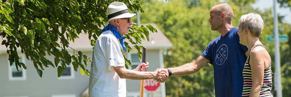 Rockhurst President shaking hands with community members