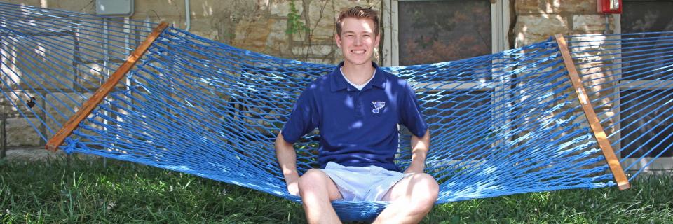 Connor Larson sits in a hammock