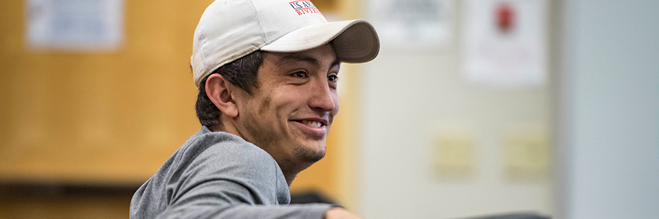 Economics Student sits in class.