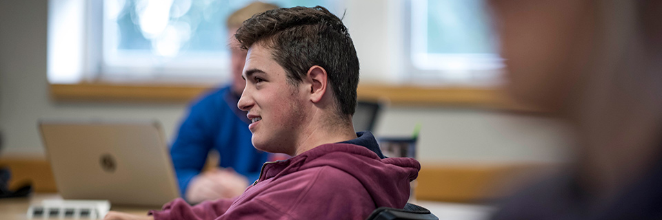 Student sits in class in Conway Hall.