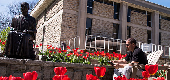 St. Ignatius Statue surrounded by flowers