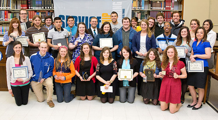 A group of students accepting awards