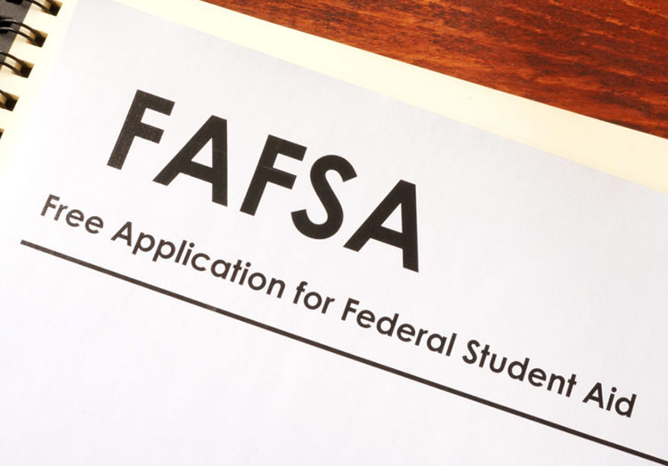 Financial Aid Application and Deadlines FAFSA paperwork on wood table