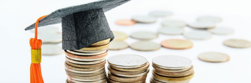 Types of Financial Aid Graduation cap on stack of coins
