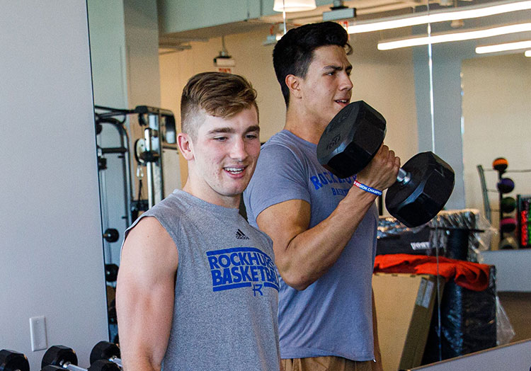 Students lifting free weights