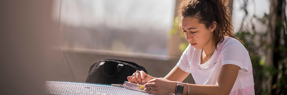 History Student reads on campus.