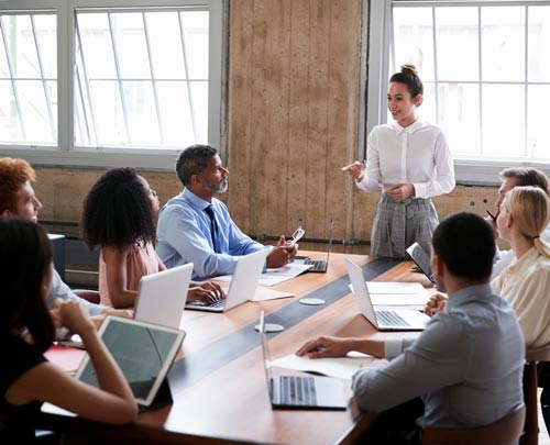 Woman leads a meeting, engaging and incorporating the ideas of her colleagues