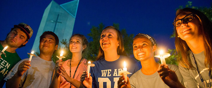 Students holding candles