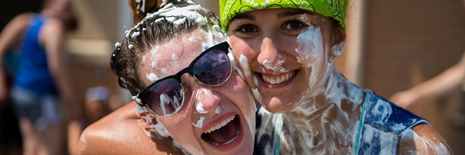 students smiling at event