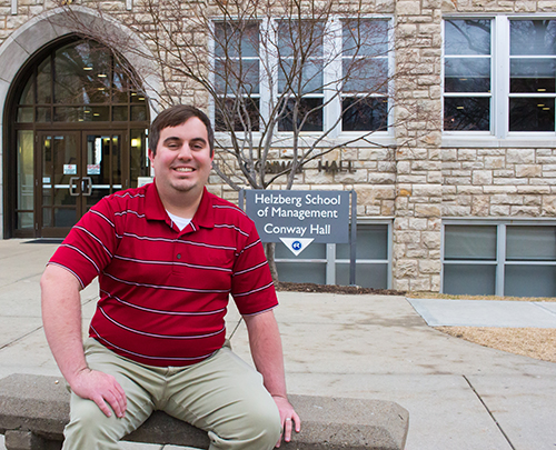 Kevin Burjarski sits on a bench outside of Conway hall