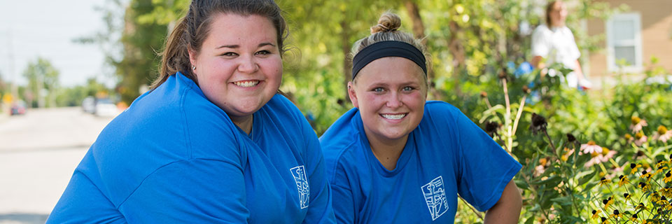 Students smiling at a service project