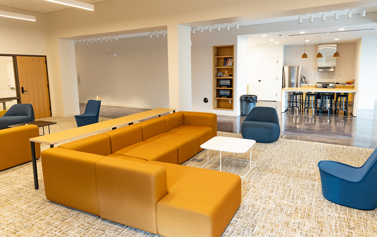 Alvin Brooks Center for Faith-Justice sitting area - couches, chairs, and bookshelf