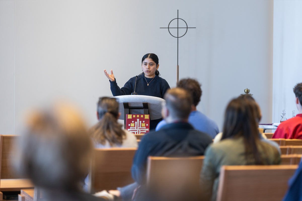 A student speaks from a podium inside Mabee Chapel 