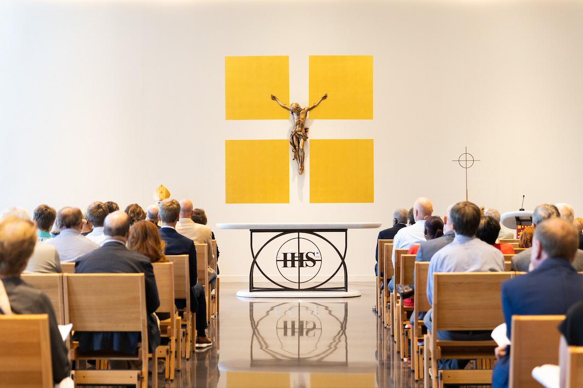 People sit in chairs in Mabee Chapel inside Alvin Brooks Center for Faith-Justice