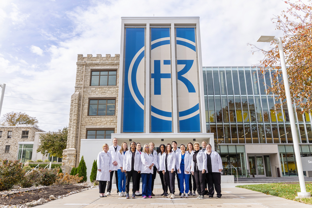 Healthcare students pose in front of Sedgwick Hall