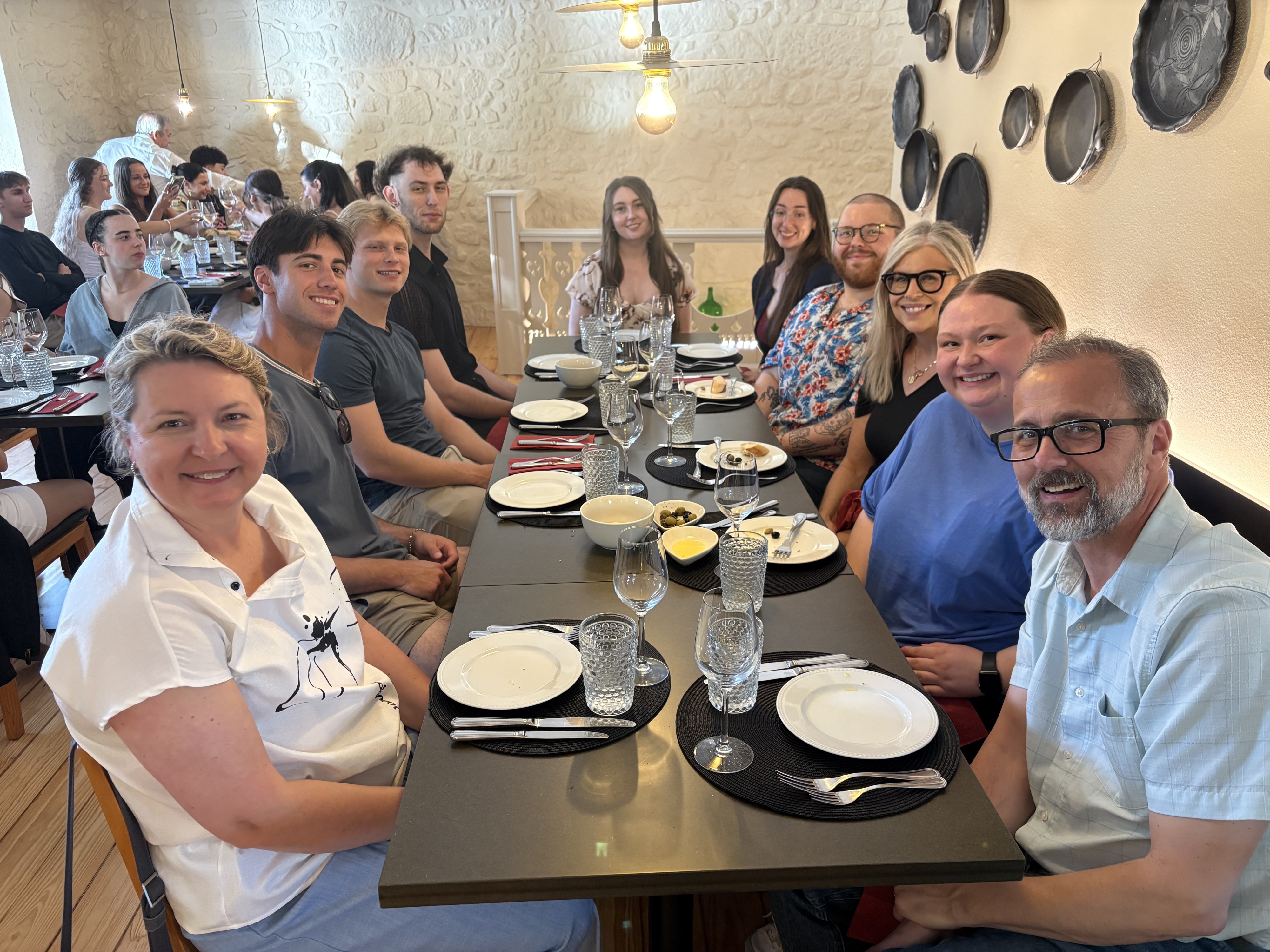 Study abroad participants look at camera while at dinner in Porto, Portugal.