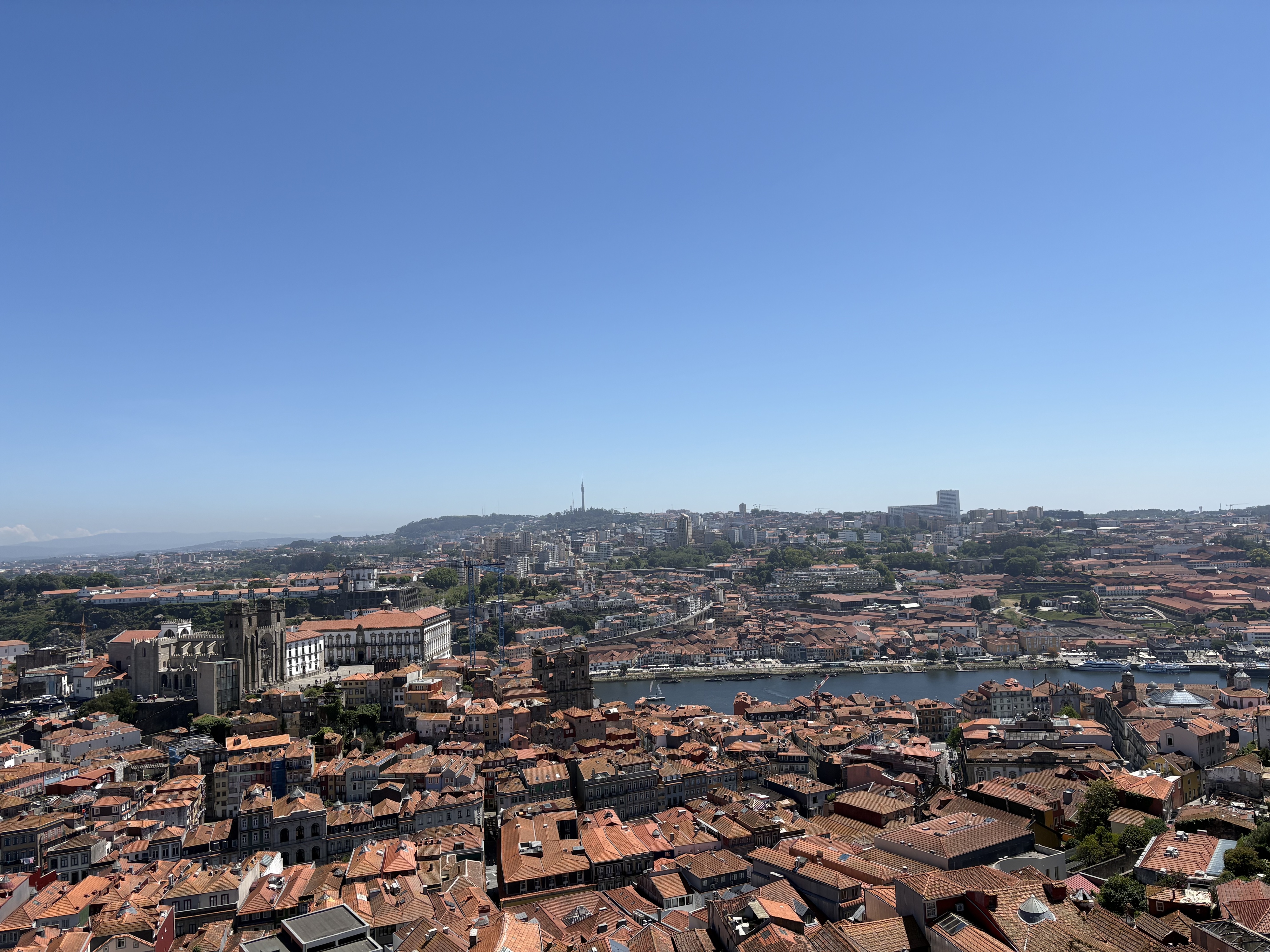 Skyline of Porto, Portugal with buildings taking up bottom half of picture and a blue sky the rest.