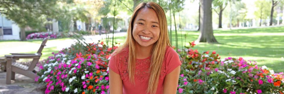Nhukha Nguyen sits near the mary statue on campus. Nhukha Nguyen, '21