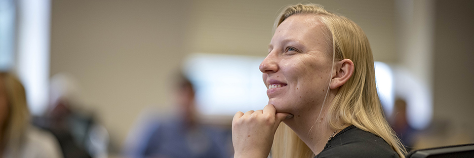 Public Policy Student looks on in class.