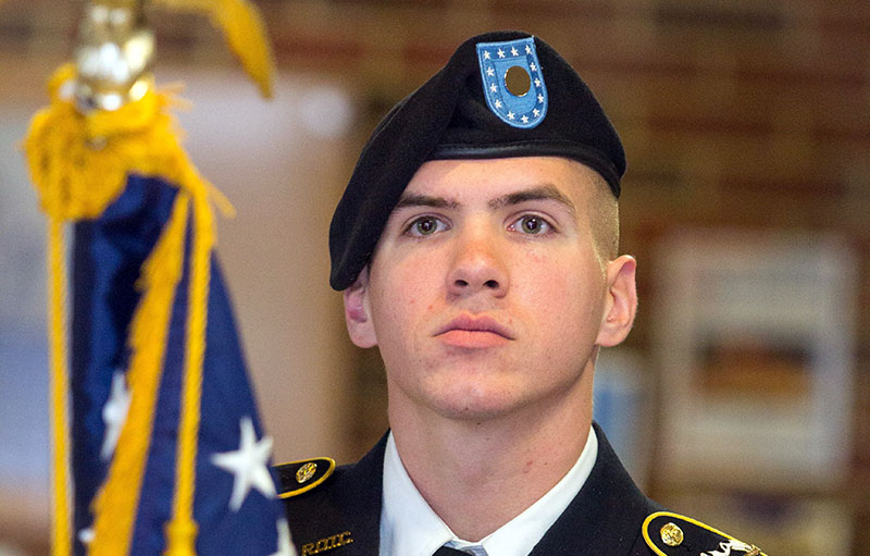 ROTC student carrying flag