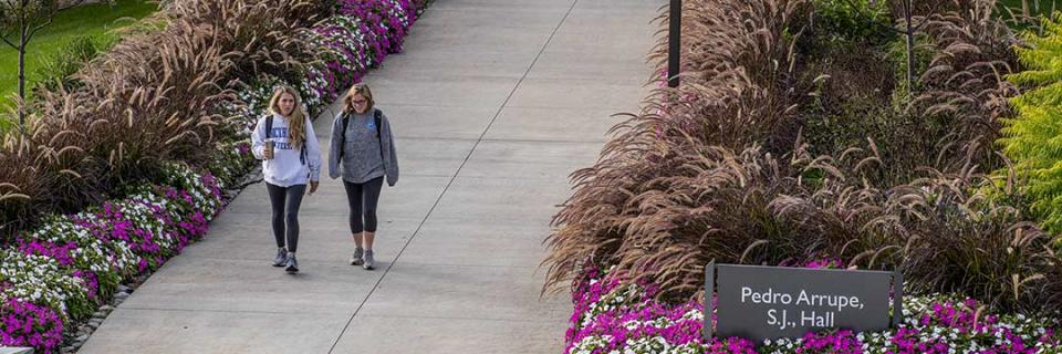 Secondary Education Students walking outside of Arrupe Hall.