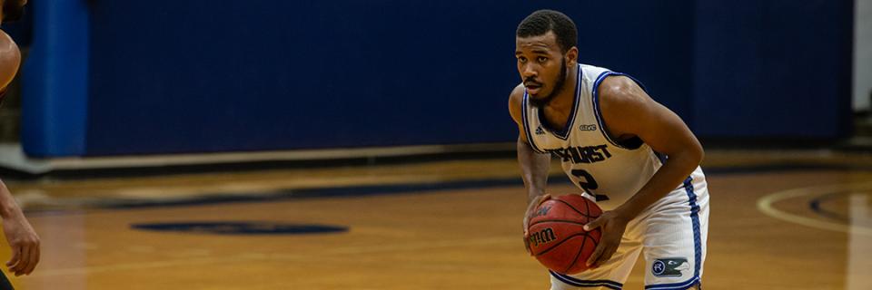 Basketball player scans the court for his next move.