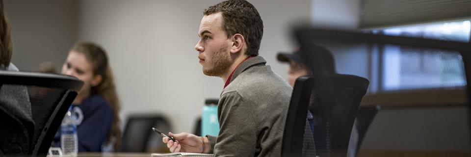 Strategic Communication Student sits in class.