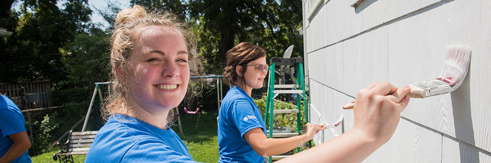 Students painting a house